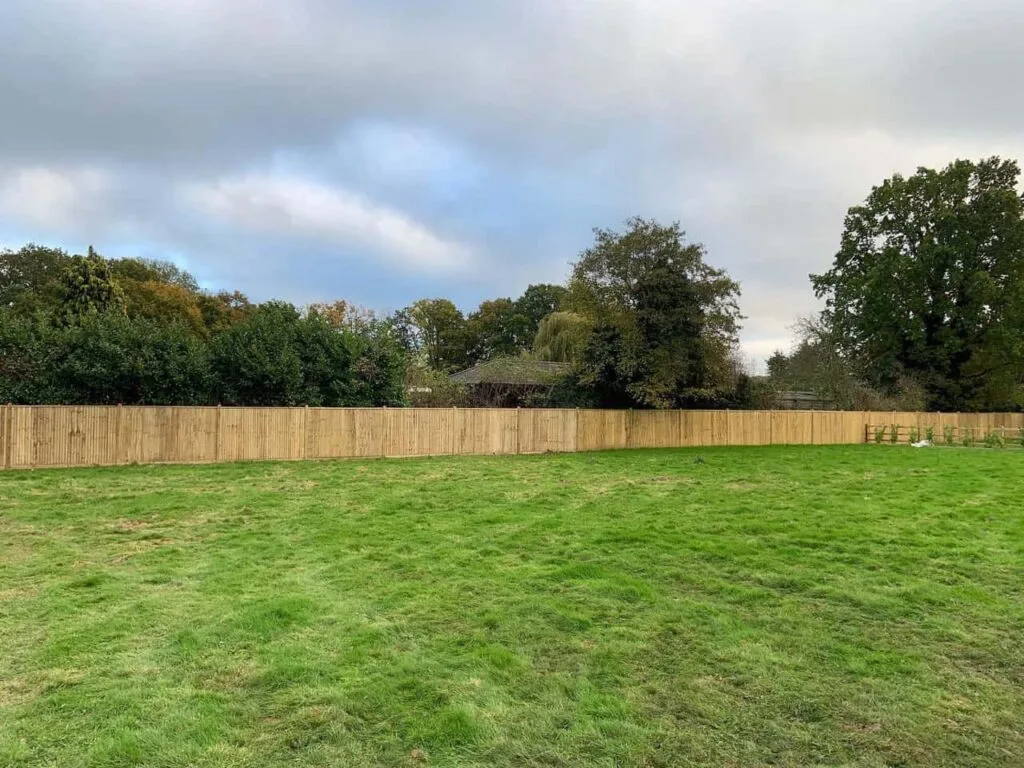 This is a photo of feather edge fencing installed around the edge of a field by Fast Fix Fencing Biggen Hill